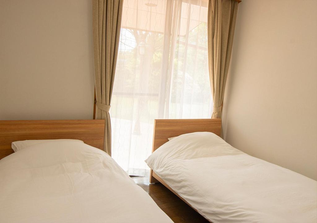 Postel nebo postele na pokoji v ubytování Villa ISE shima
