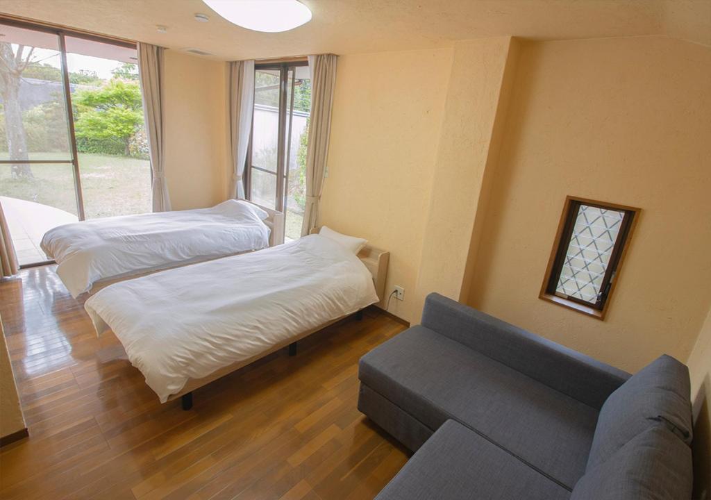 Postel nebo postele na pokoji v ubytování Villa ISE shima
