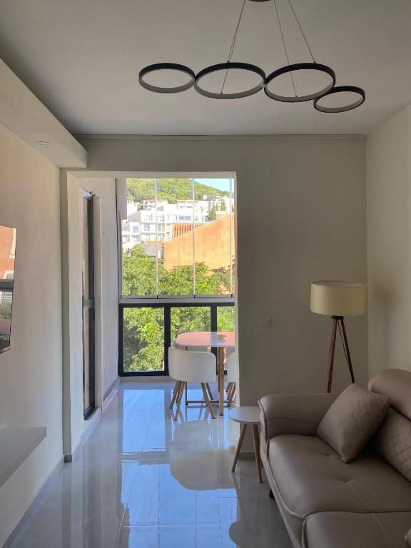 a living room with a couch and a table at Central Prestige Apartment in Budva