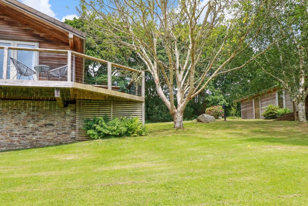 a house with a deck and a yard at 3 Lake View in Looe