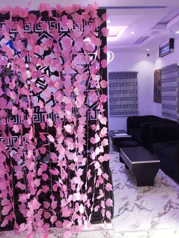 a room with a wall covered in pink flowers at City End Luxury Hotel and Apartments in Ikorodu