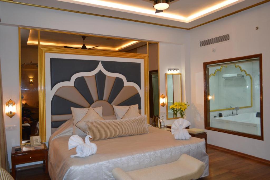 a bedroom with a large bed with towels on it at Hotel Clarks Shiraz in Agra
