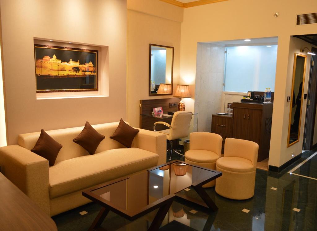 a living room with a couch and a table at Hotel Clarks Shiraz in Agra