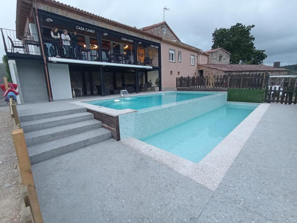 a swimming pool in front of a building at A Casa Da Canle in Braño