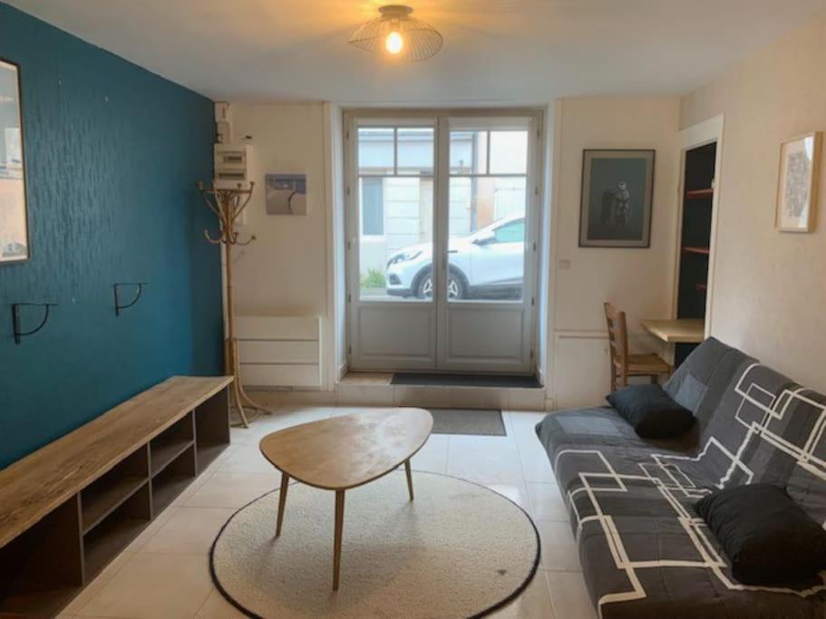 a living room with a couch and a table at Maison Frères Prêcheurs in La Rochelle
