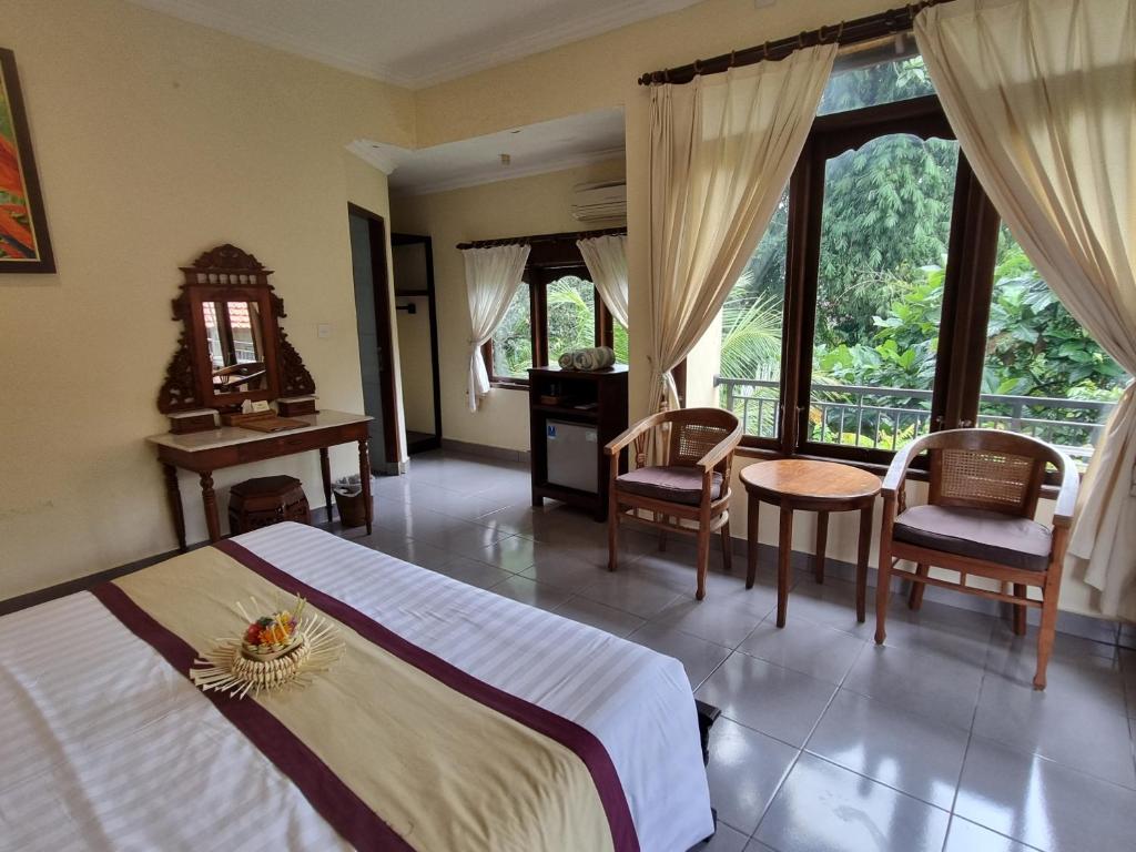 Postel nebo postele na pokoji v ubytování Nyoman Sandi Guest House