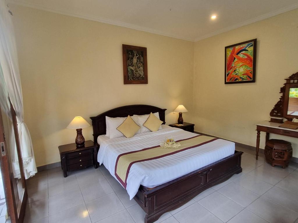 Postel nebo postele na pokoji v ubytování Nyoman Sandi Guest House