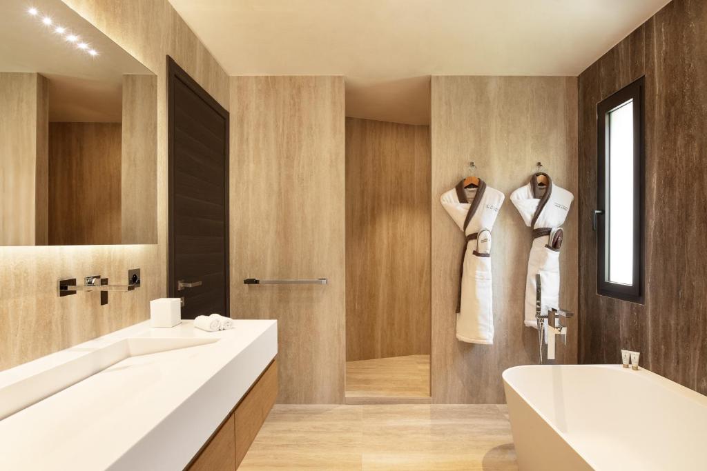 a bathroom with two sinks and a tub and a shower at Villa Cosy, hotel & spa in Saint-Tropez