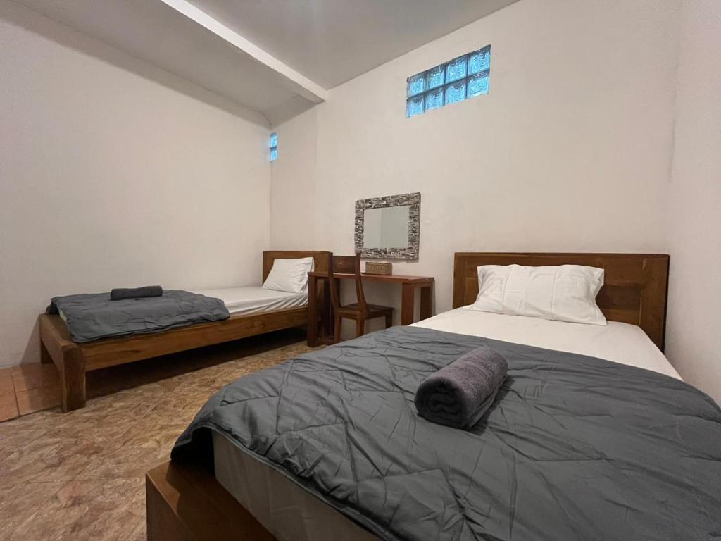 Postel nebo postele na pokoji v ubytování ODA Guest House Ubud