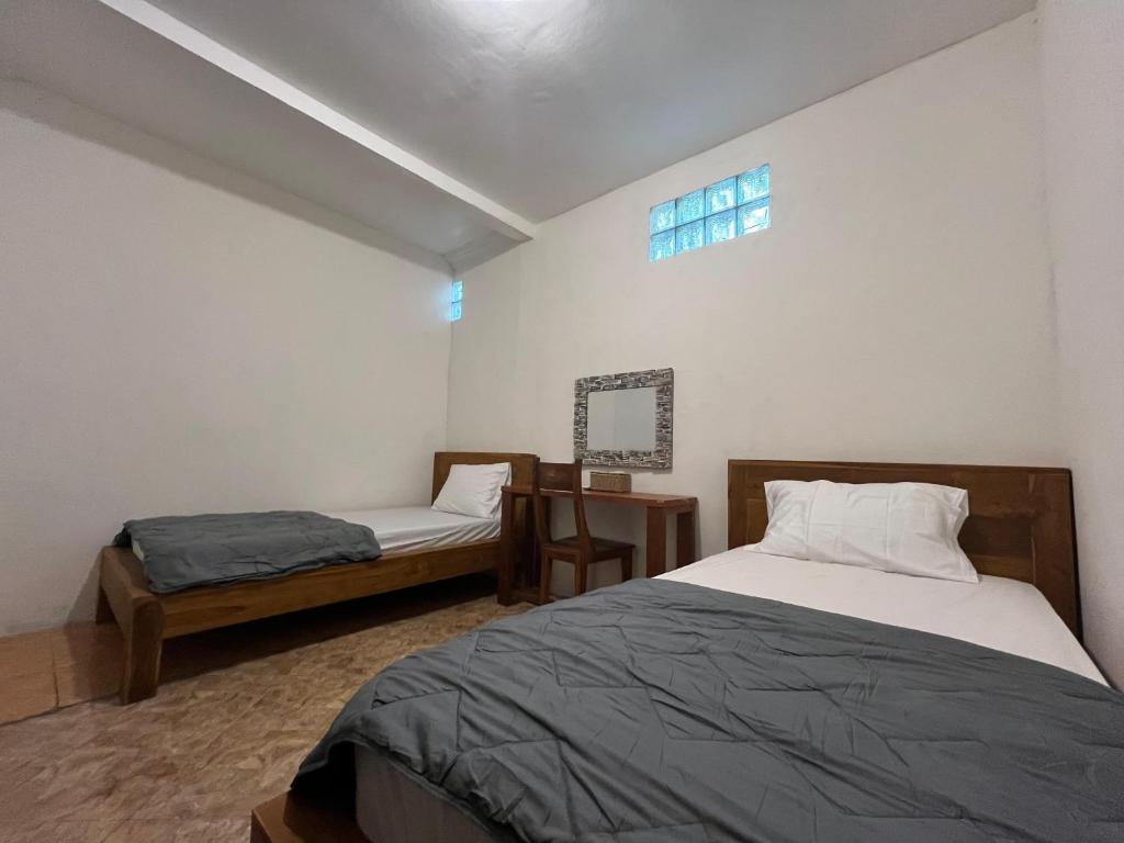 Postel nebo postele na pokoji v ubytování ODA Guest House Ubud