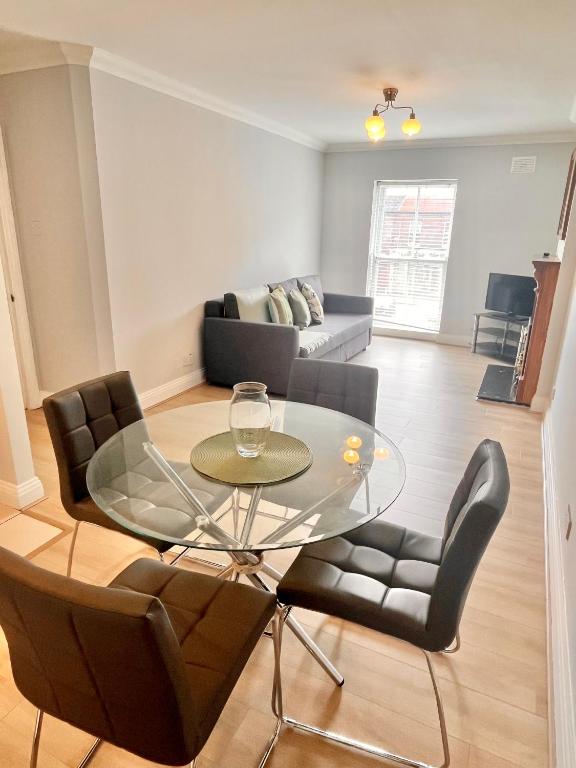 a living room with a glass table and chairs at Dublin City Apartment - 2 bedrooms in Dublin