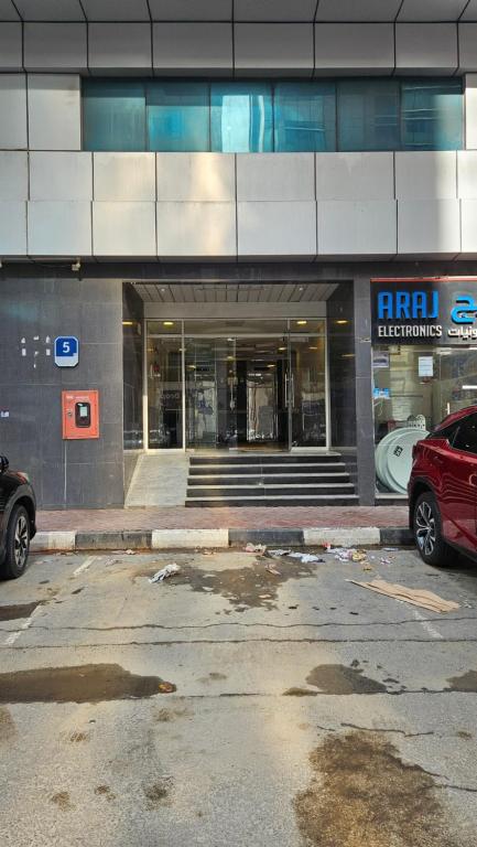 an empty parking lot in front of a building at Hostel Faye in Abu Dhabi