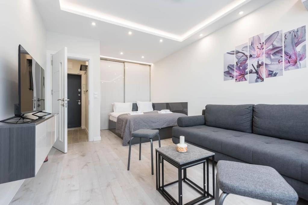 a living room with a couch and a bed at Sweet tiny top center space in Varna City