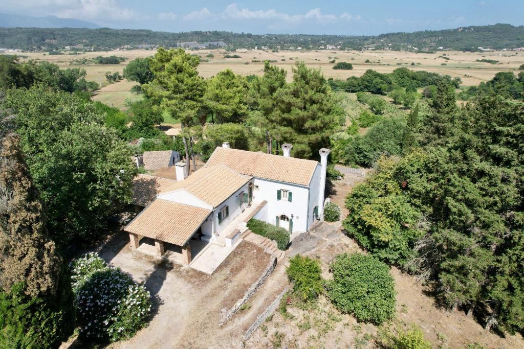an aerial view of a white house with trees at Charming Villa for nature lovers in Theotoky Estate Vineyard and olive mill in Corfu