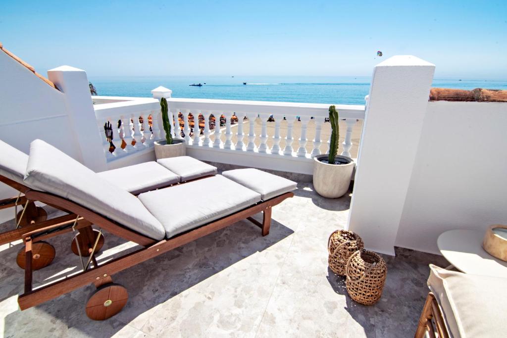 a balcony with a bench and the ocean in the background at Mara's Apartments Torremolinos SeaViews -Beachfront - Duplex Penthouse in Torremolinos