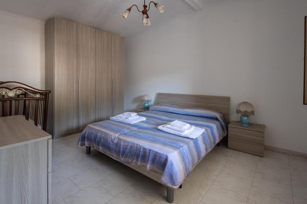 a bedroom with a bed with two towels on it at Casa vacanze da Nicola in Saponara Villafranca