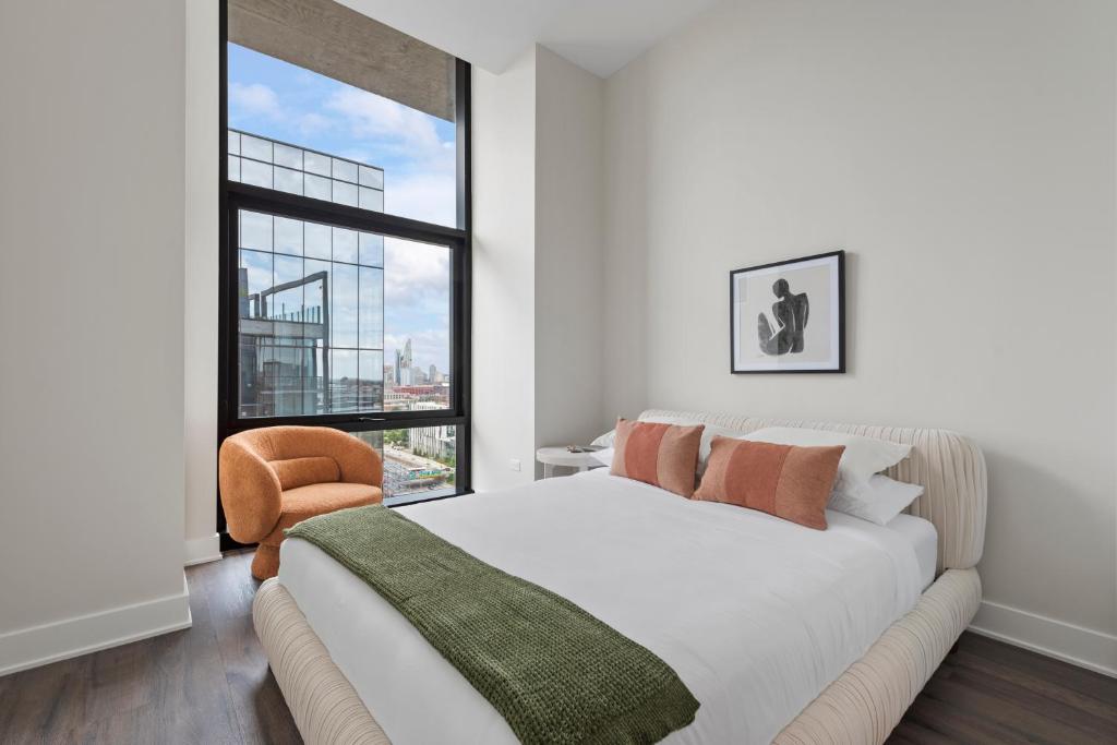 a bedroom with a bed and a large window at Avra Stylish Apartments Prime West Loop Location Near Union Park in Chicago