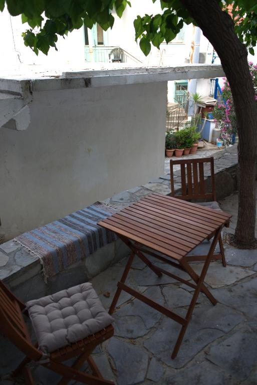 a picnic table and a chair on a patio at Sufiko Studios - Drosia in Armenistis