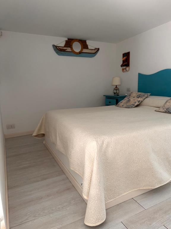 a bedroom with a white bed and a blue table at La Bella Annacapri in Anacapri