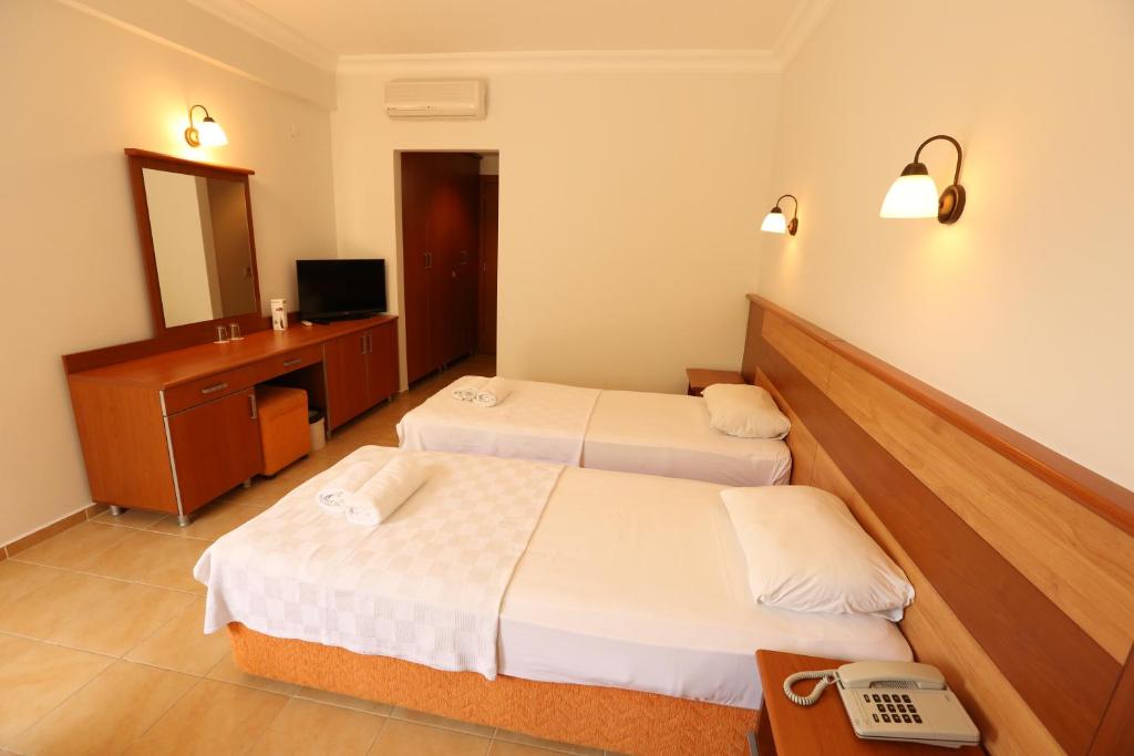 Postel nebo postele na pokoji v ubytování Mavruka Hotel