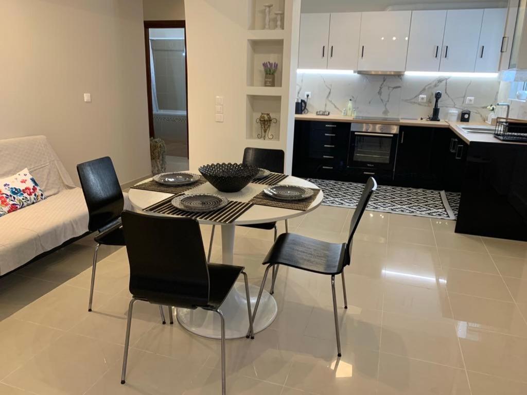 a kitchen and a table and chairs in a room at Vagias Home in Kanali
