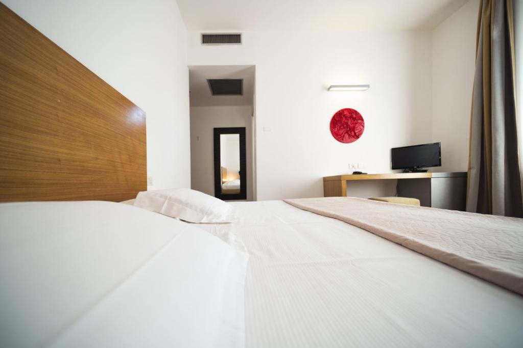 Postel nebo postele na pokoji v ubytování Hotel Trieste