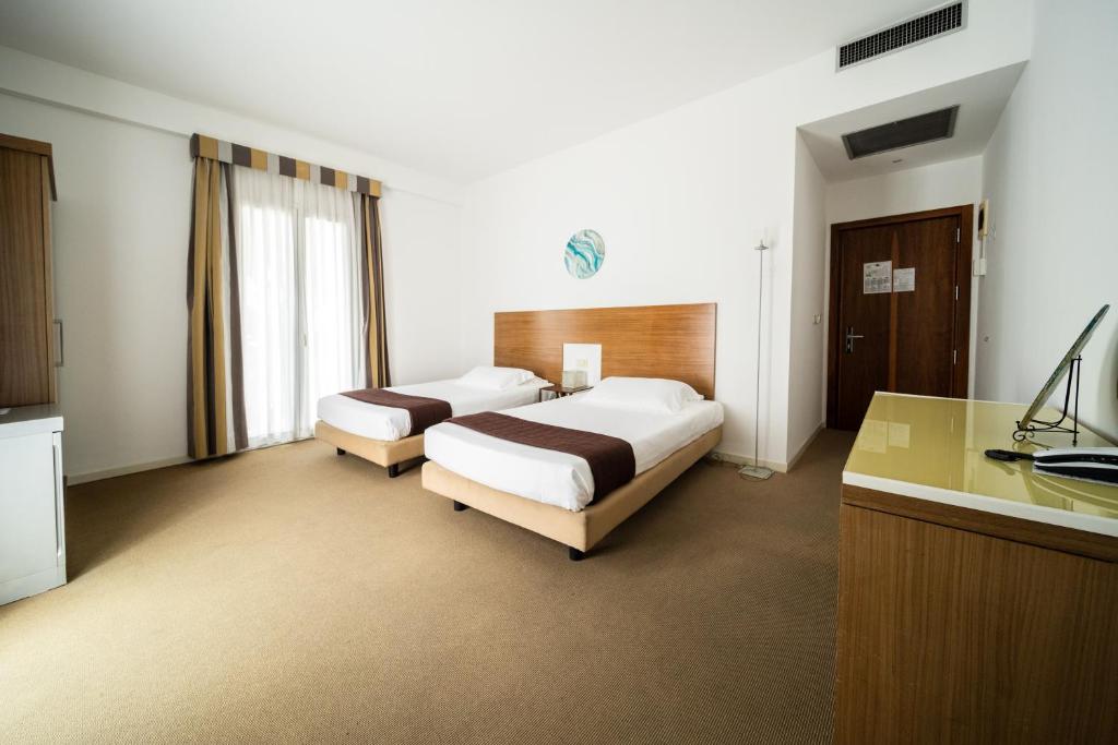 Postel nebo postele na pokoji v ubytování Hotel Trieste