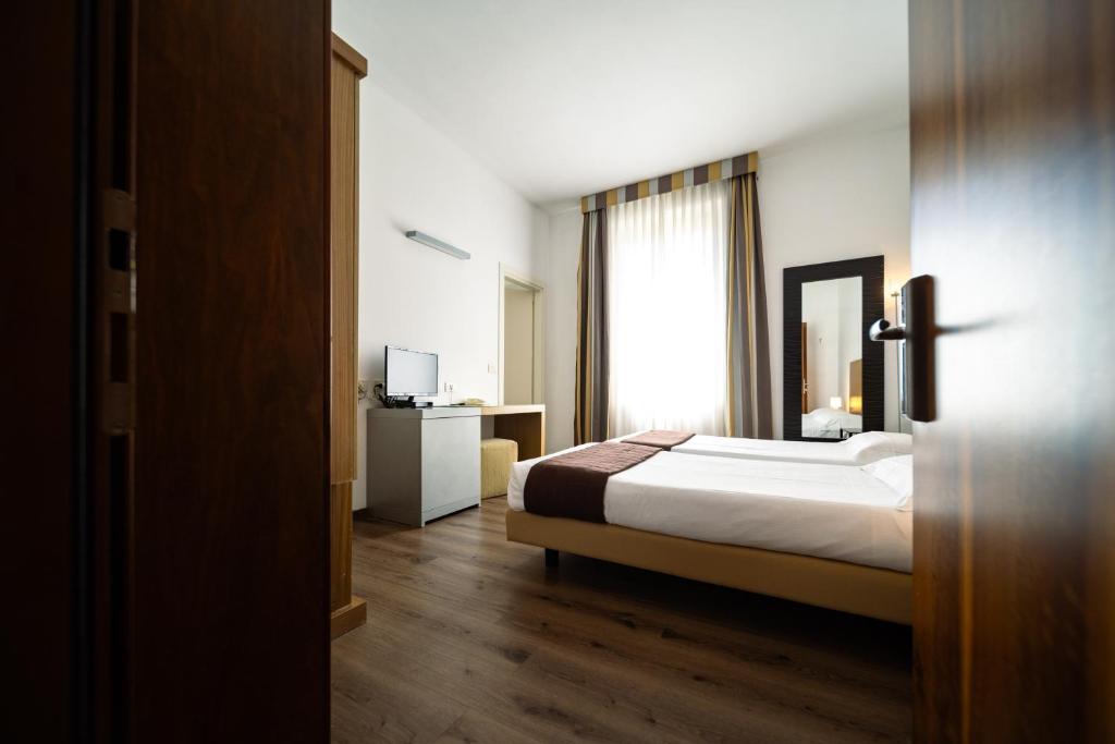 Postel nebo postele na pokoji v ubytování Hotel Trieste