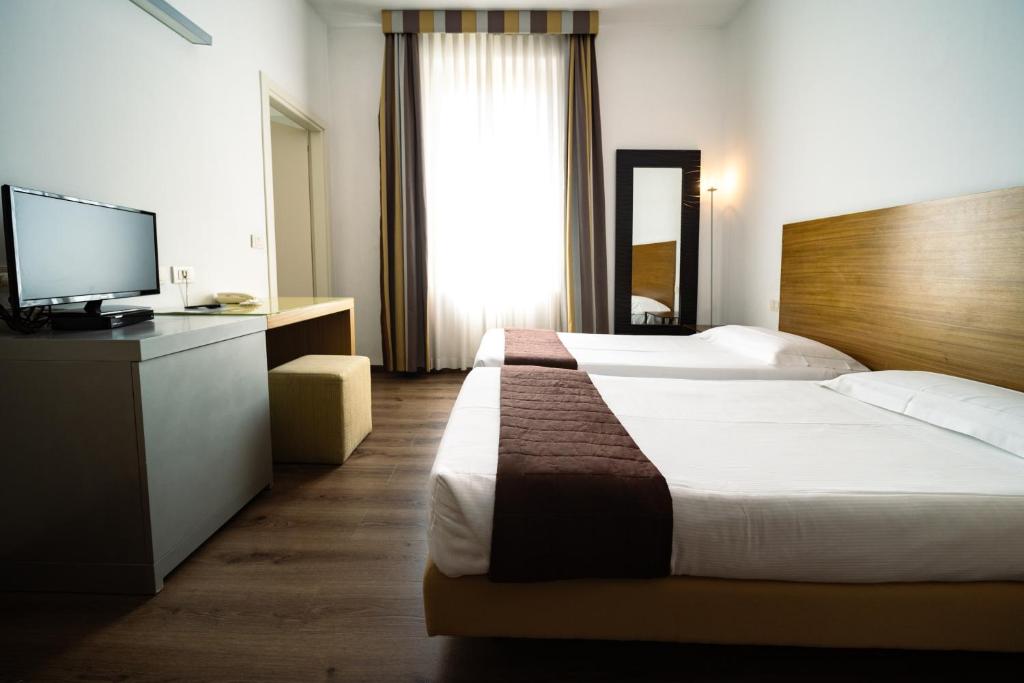 Postel nebo postele na pokoji v ubytování Hotel Trieste