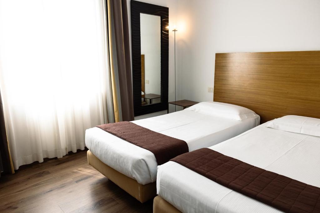 Postel nebo postele na pokoji v ubytování Hotel Trieste