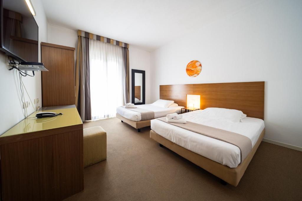 Postel nebo postele na pokoji v ubytování Hotel Trieste