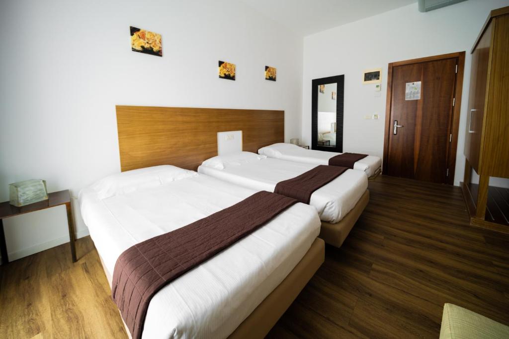 Postel nebo postele na pokoji v ubytování Hotel Trieste