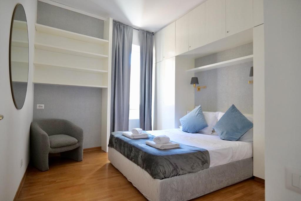 a bedroom with a bed with a chair and a window at Loft 5c - Palatino in Rome