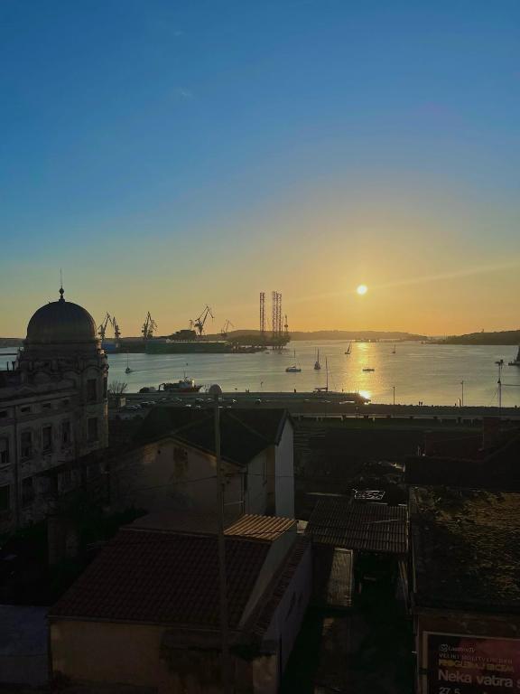 a sunset over a harbor with a river and a city at Dejan apartment 3-Free parking near Arena in city center, near bus, train, ferry, airport shuttle in Pula