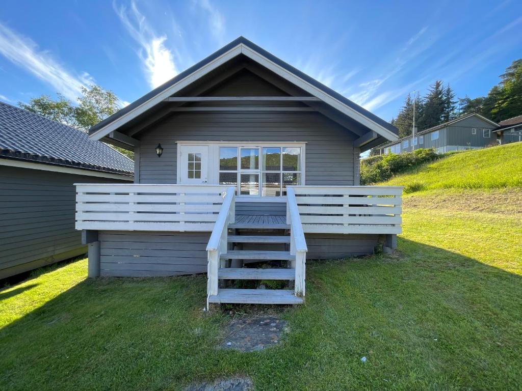 a house with a staircase in front of it at Hytte Nr 2 in Selje