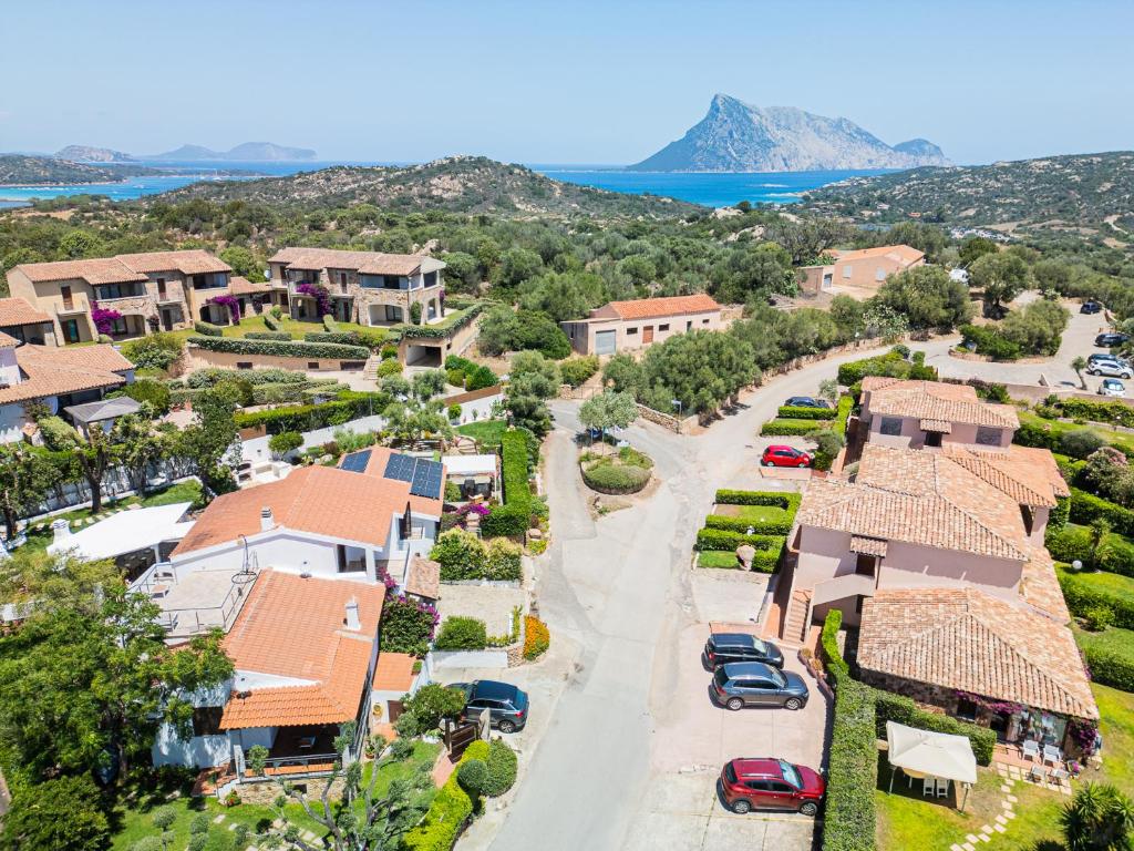 an aerial view of a resort with cars parked in a driveway at Casa Masini San Teodoro in Monte Petrosu
