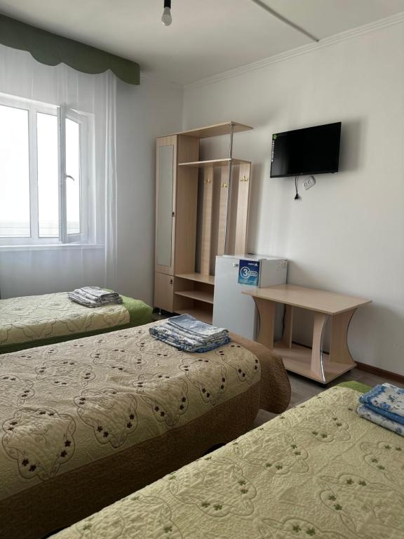 Postel nebo postele na pokoji v ubytování Guest House Arbat