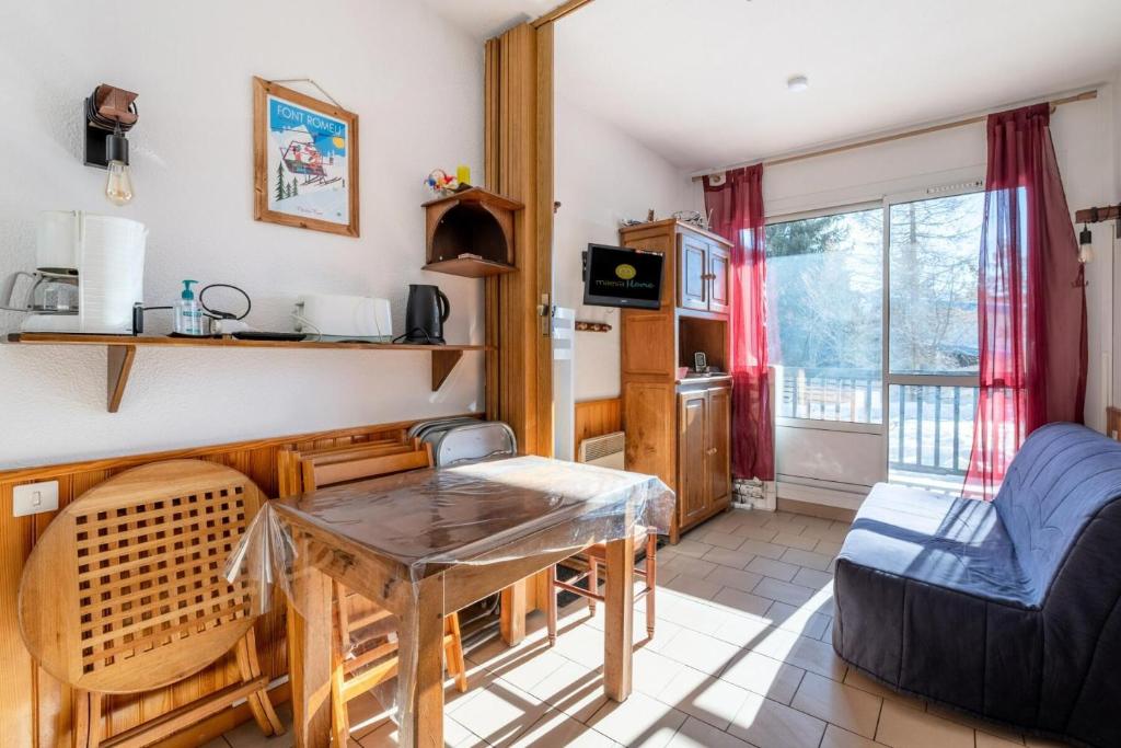 un salon avec une table et un canapé dans l'établissement Résidence Val Cristal - maeva Home - Studio 5 Personnes - Budget MAE-2444, à Font-Romeu-Odeillo-Via