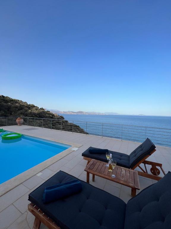 a villa with a swimming pool next to the ocean at VL Luxury Villa in Kiveri