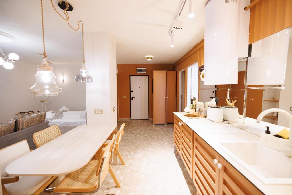 a kitchen with a table and chairs and a sink at Bear's Apartment Suite Alba Iulia in Alba Iulia
