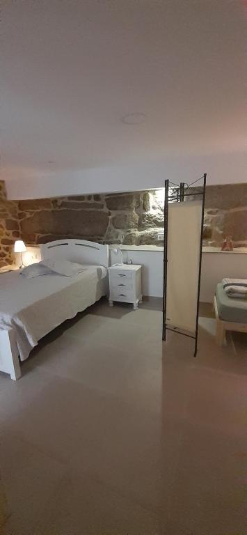 A bed or beds in a room at Hostal Casa Martinez