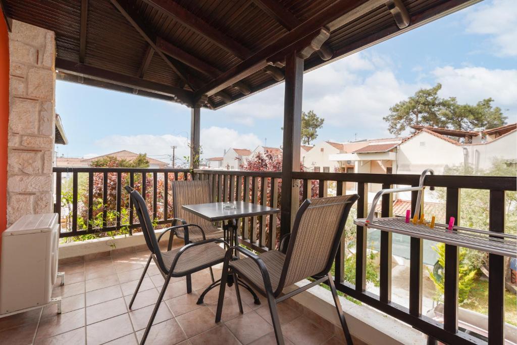 a patio with two chairs and a table on a balcony at Hotel Aeollos in Pefkochori