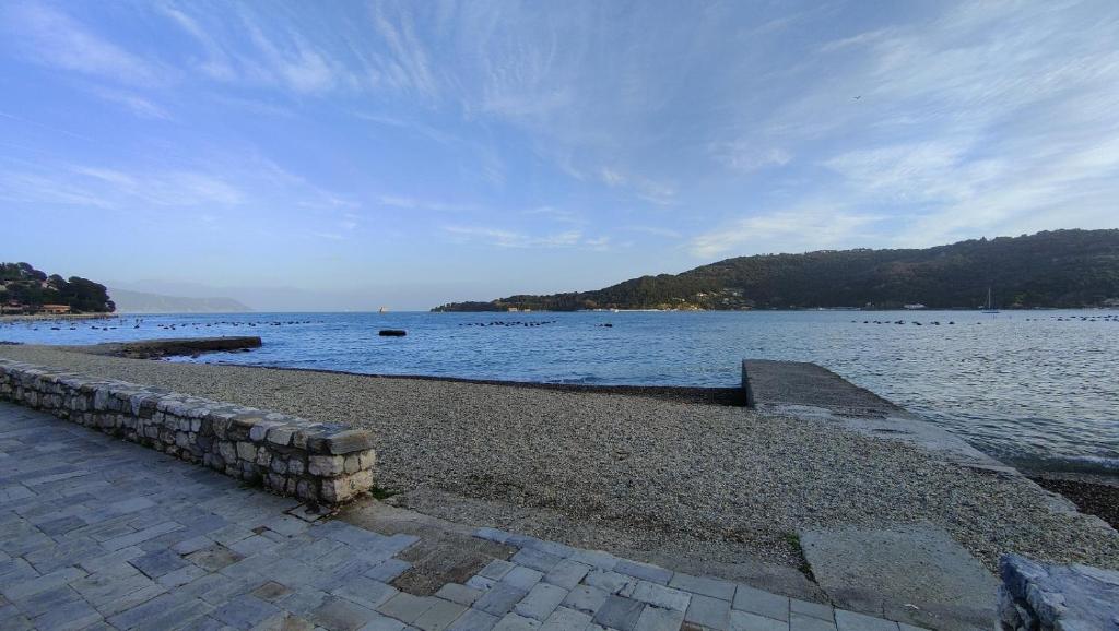 a large body of water with a stone wall at A due passi dal mare in Portovenere
