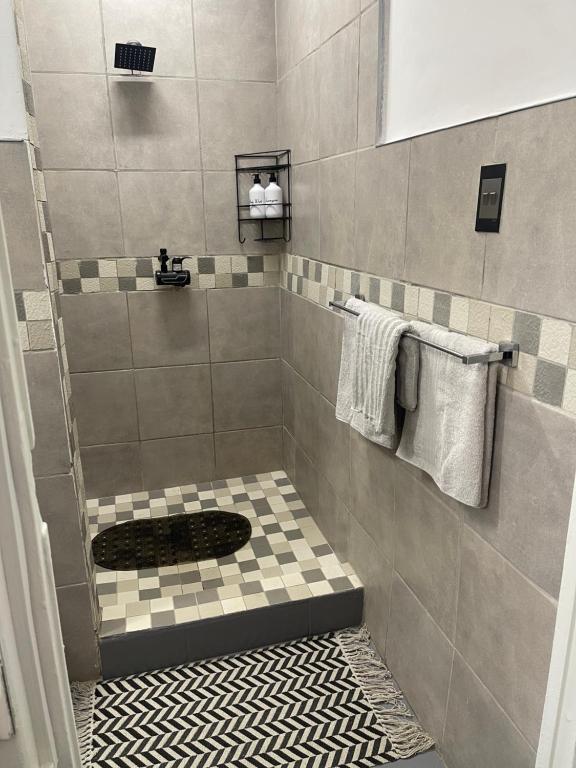 a bathroom with a shower with a toilet in it at Private Cosy Cottage on Pelican in Durban