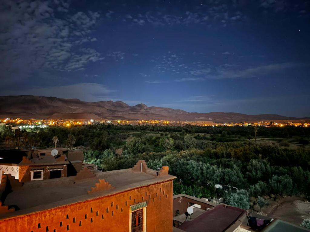 a view of a city at night from a building at Hike and Chill Homestay in Tinerhir