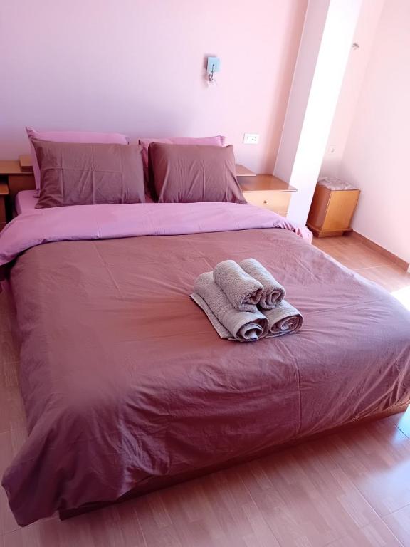 a large bed with two towels on top of it at Sunset hellen in Katsíkia