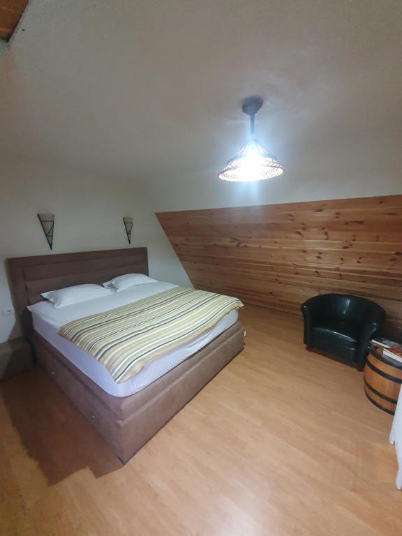 a bedroom with a large bed and a light at Holiday Home Vile Calimero in Žabljak