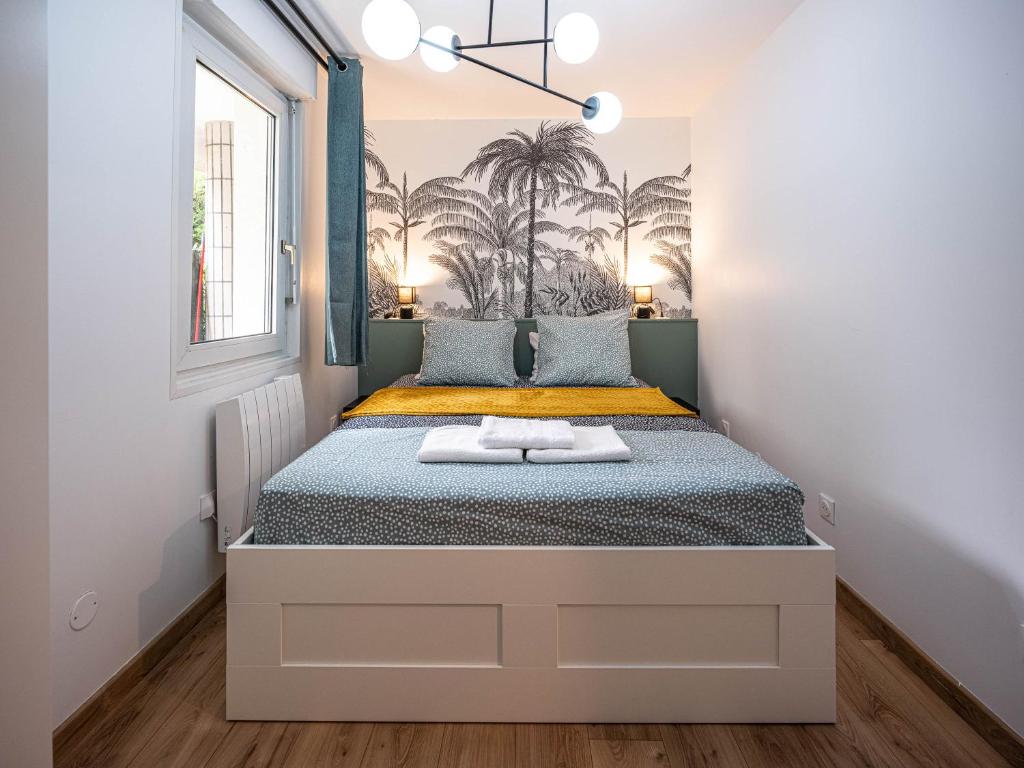 Ένα ή περισσότερα κρεβάτια σε δωμάτιο στο Appartement cocooning en centre-ville - Résidence le Colisée