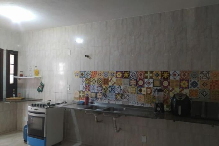 a kitchen with a sink and a stove at Flor de Lis in Salvador
