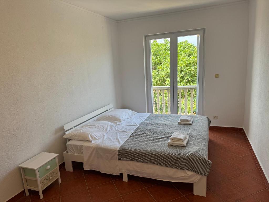 Postel nebo postele na pokoji v ubytování Apartments Prosika
